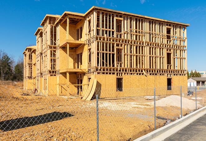 a close-up of temporary chain link fences enclosing a job site, signaling progress in the project's development in El Cajon